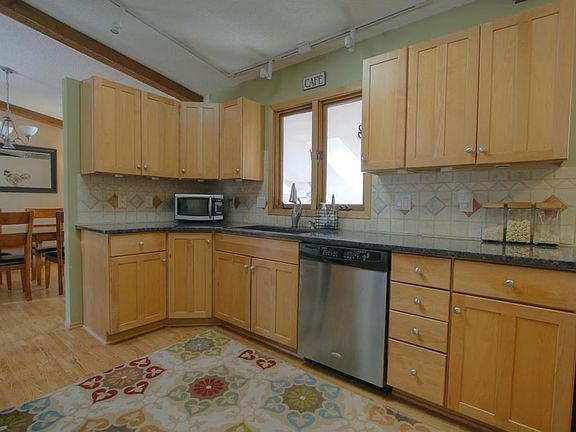 Modern countertops and tiled backsplash.