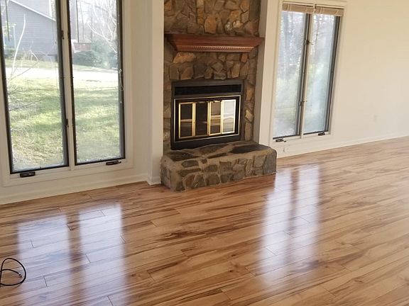 Great room with stone fireplace and hardwood floor,cathedral ceiling