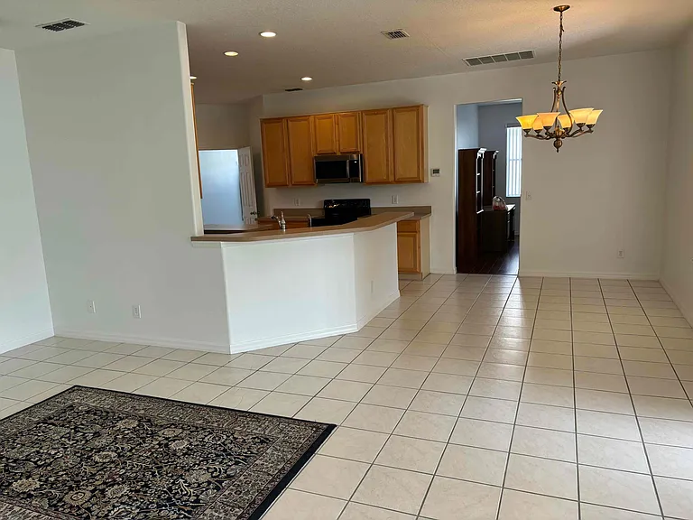 Family room, kitchen and dining nook showing entrance to den area