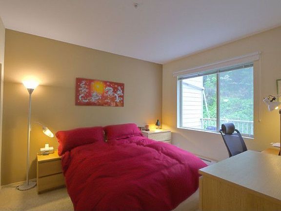 Bedroom with picture window overlooking peaceful greenbelt!