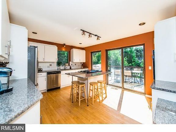 Bright remodeled kitchen with brand new granite counter tops, stainless fridge, dishwasher, oven top, and in-wall oven! Sliding doors lead to back yard deck.