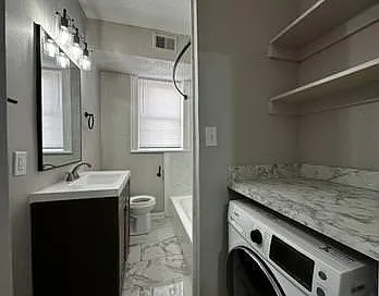 2 in 1 unit with shelves above in bathroom