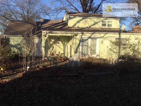 Nicely landscaped backyard with trees.