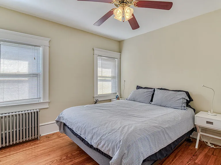 East-facing middle bedroom has queen size bed, 2 bedside tables, large dresser, ceiling fan, closet, 40" smart TV