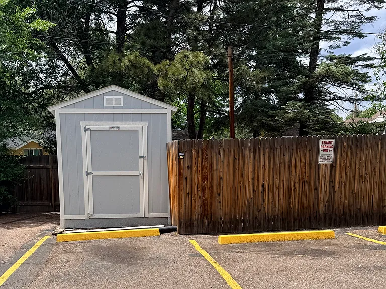 Storage shed with two dedicated parking spaces
