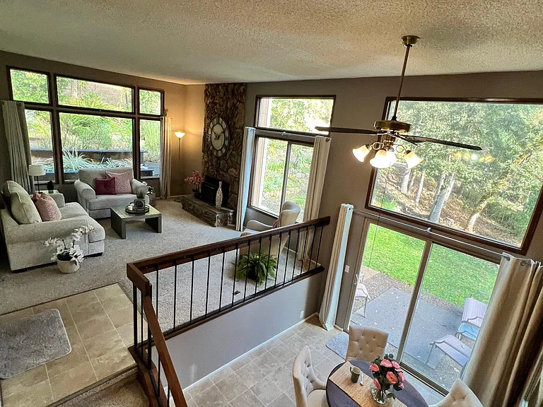 Great Room filled with outdoor views. Heat pump warms or cools your home efficiently and economically.