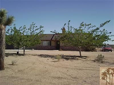 Front of home with mature trees