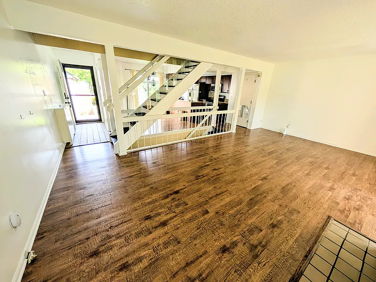 Living room angle 2 looking at stairs and dining space