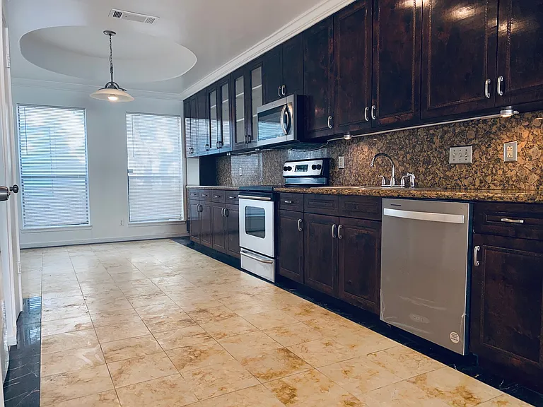 The kitchen features a breakfast nook with ample cabinetry, sleek granite countertops a pantry and stainless-steel appliances.