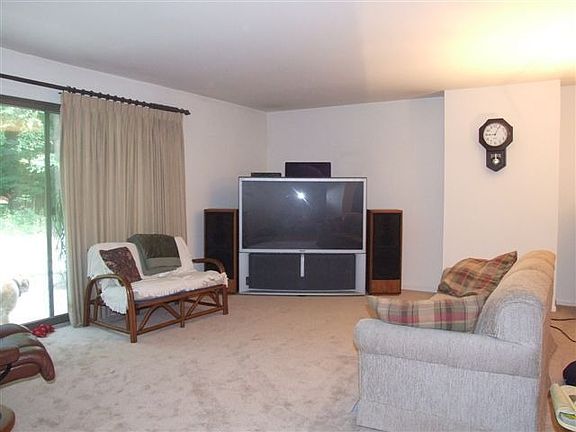 Large living room shown with 65" tv