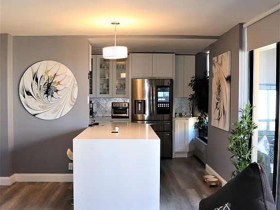 Open Concept kitchen with an oversized Quartz island