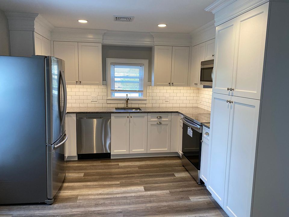 Brand new everything in this custom kitchen. Crown molding, granite counter tops, subway tiles, dishwasher, microwave, range, fridge. Large pantry. Dimensions are 14' x 11'.