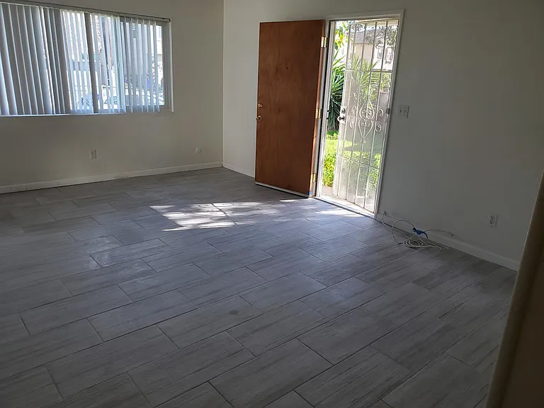 House has double entry. One side from Livingroom. This is Livingroom view from hall way of bedrooms.