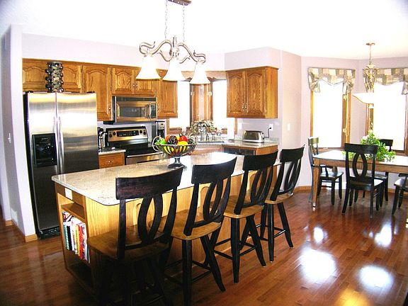 Kitchen with granite counter tops, maple hardwood floors & stainless appliance