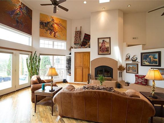 Living room overlooking the fireplace and Outdoor Patio, High Ceilings, Wood Floors, Loads of Natural Light