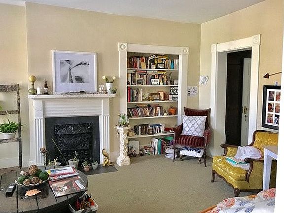 Living room with mantel and built-in bookcase