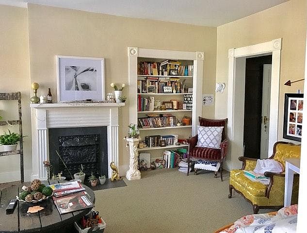 Living room with mantel and built-in bookcase