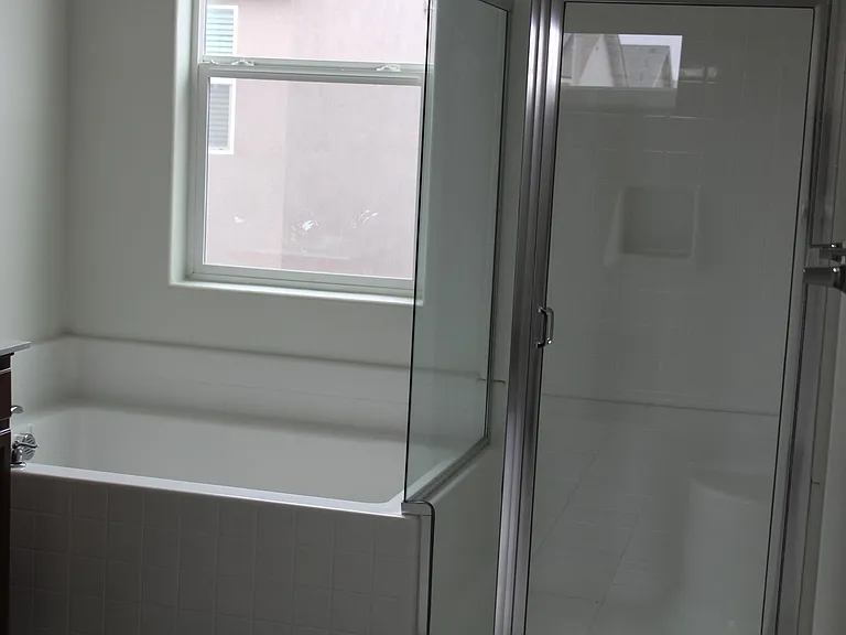 glass enclosure shower in master. beside the master oversized tub