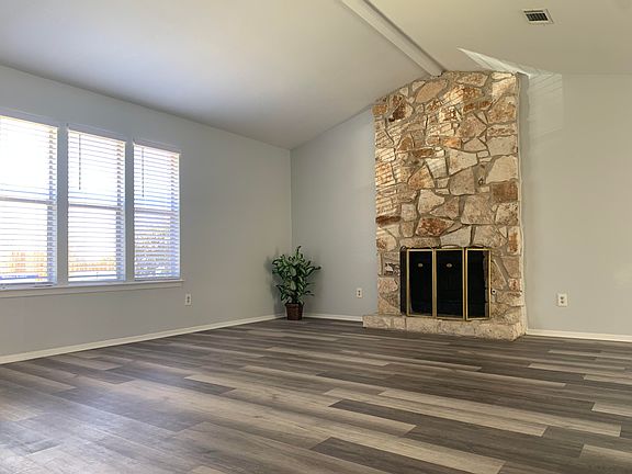 bright, vaulted ceiling living room with natural light