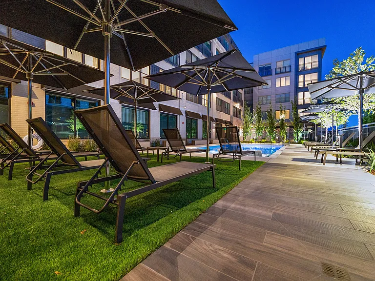 Resort style pool deck with shaded seating areas