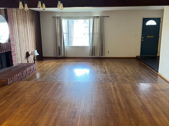 View of the front door and window of living room/dining room downstairs.
