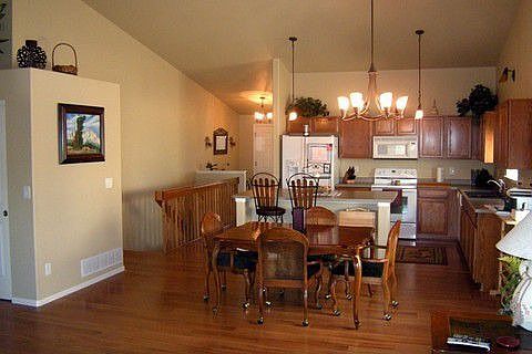 Open floor plan with extensive wood flooring