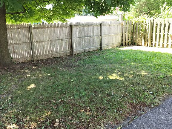 Fenced in back yard behind garage.