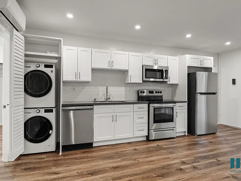 Kitchen with Energy-Efficient Stainless Appliances and In-Suite Washer & Dryer