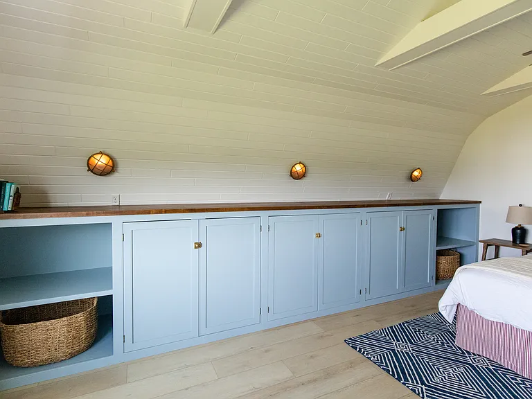 The master room includes a king size bed, built-in closet space, a dresser, a desk, and a smart TV