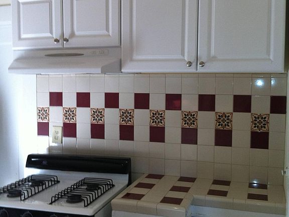 Kitchen with gas stove and outside vented range hood