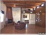 Great room, rough sawn beams, beehive fireplace, and media room