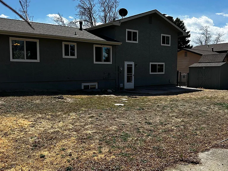 fenced back yard with shed