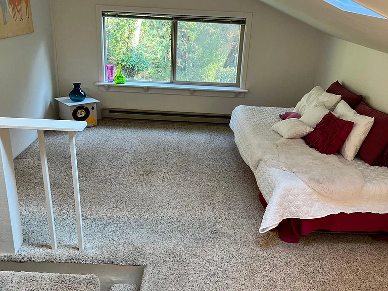 Loft has two skylights, 8' closet, soft built in seat, 6' window overlooking lawn and gardens.