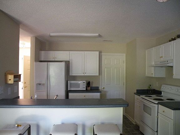 The kitchen features a bar-height countertop