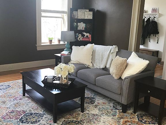 Living room with furniture--windows have city views. The living room has room for an area rug as big as 10 x 15!