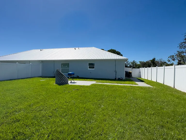 Large fenced yard offering privacy and freedom for pets in this Sebring rental home.