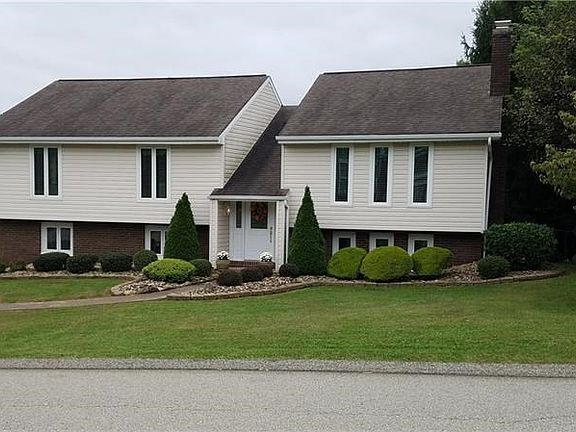 Very well groomed landscaping including landscape stone, fenced in rear yard, and a raised bed garden.