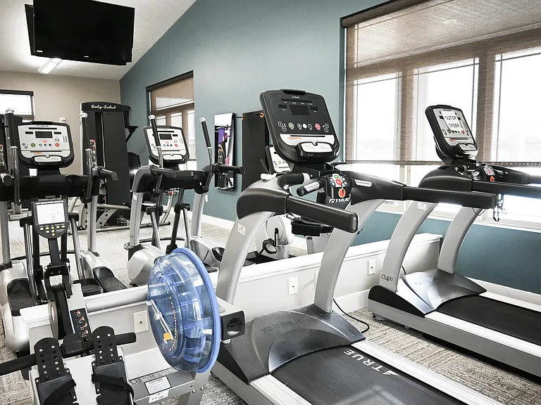 Treadmills and elliptical machines in the gym at The Sterling.
