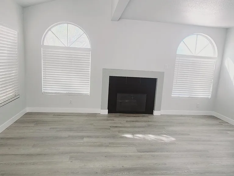 Bright, airy living room with gas fireplace.