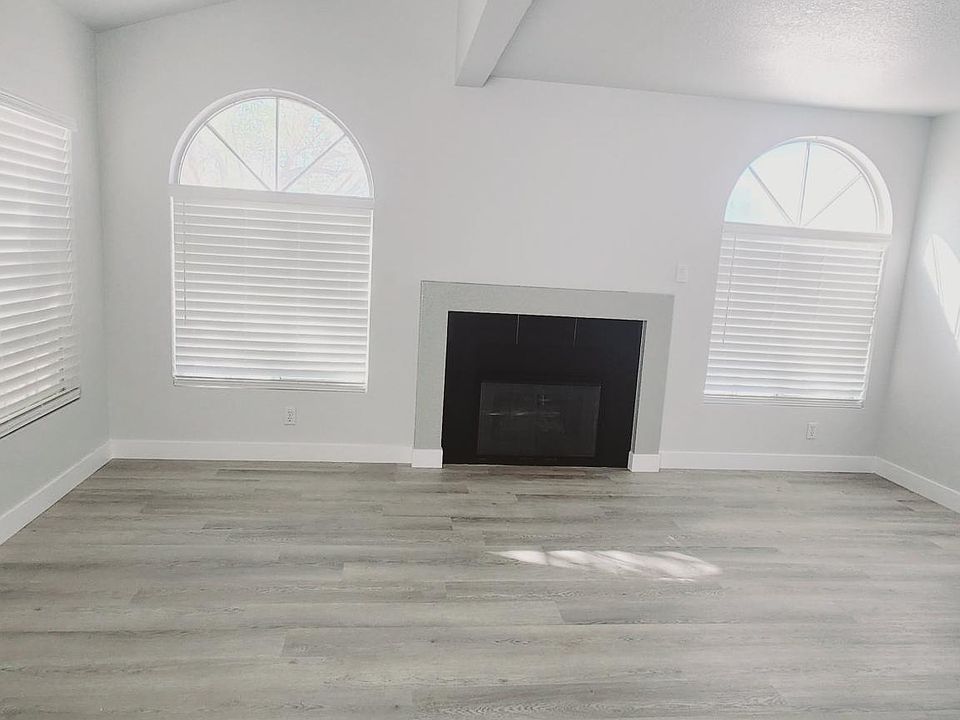 Bright, airy living room with gas fireplace.
