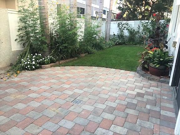 Private Backyard with pavers, grass with locked gate and automatic sprinklers. Gardener comes once a week to maintain.