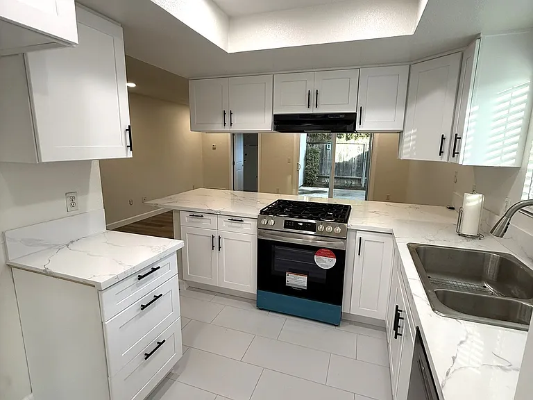 Kitchen viewed from dining room with a place for refrigerator on the left and pantry on the right (out of view)