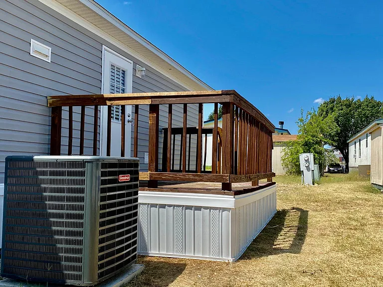 Back porch with large 4 ton ac and a shed.
