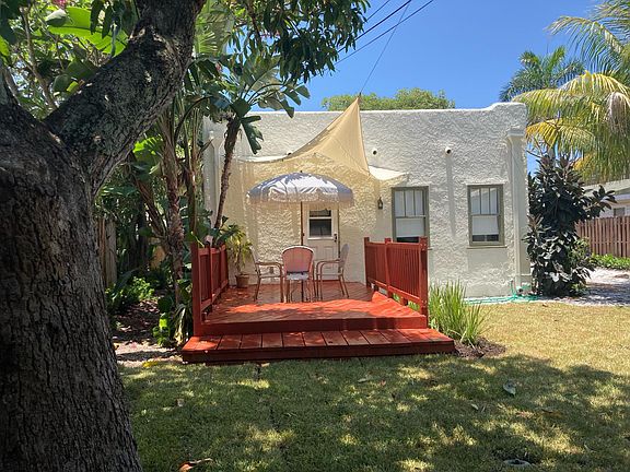 Large fenced in backyard with deck.