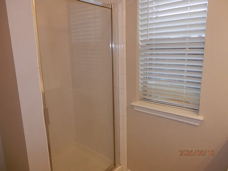 Primary bathroom also has stand up shower