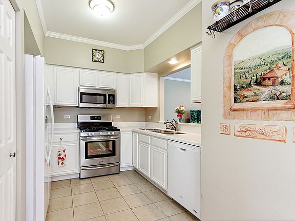 Kitchen features heated tile floor, all appliances, Corian Countertops, pantry closet and a eat in table area.