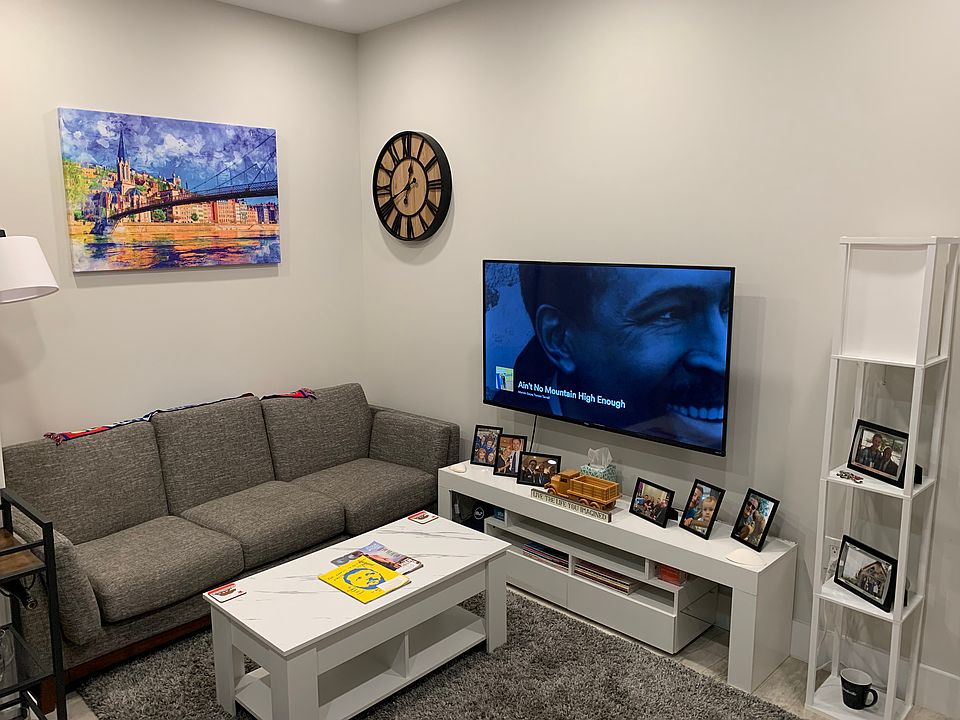 Fully furnished living space with 55" mounted Smart TV.
