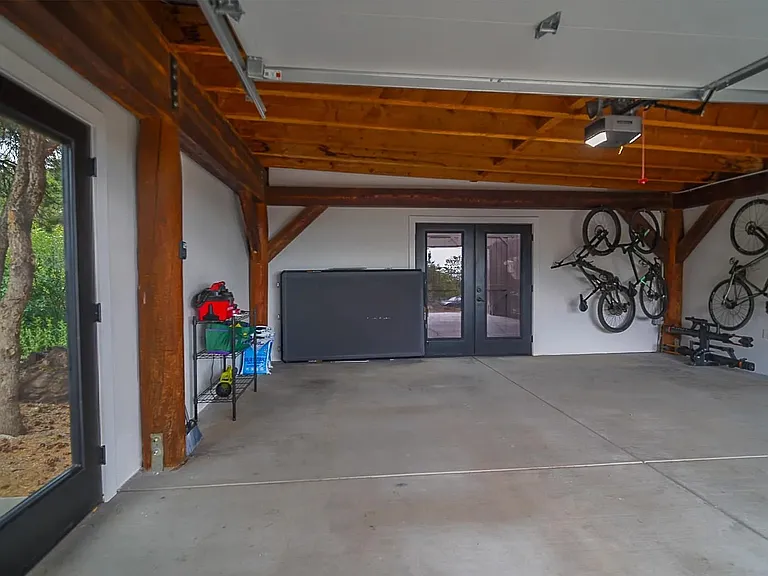 Inside of recently built garage with lots of natural light & motion-detection flood lights