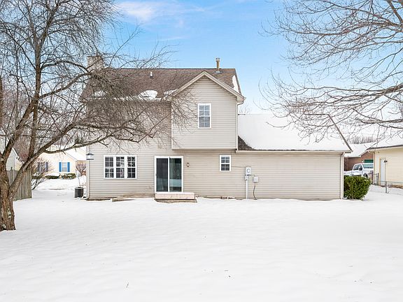 Back view of the house showing large backyard with all three sides fenced