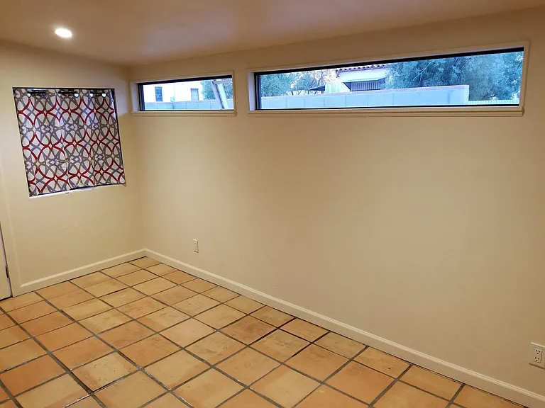 Large bedroom with Saltillo tile, lots of light, but still private and cozy with door to the front.